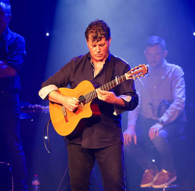 Chris Kelly playing guitar at Trad on the Prom