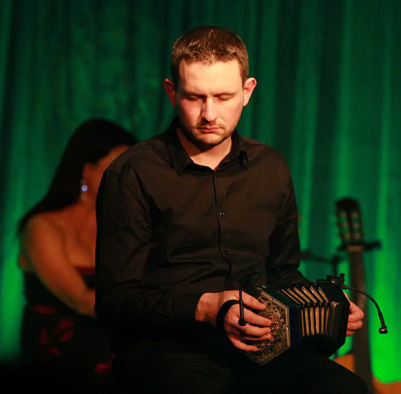 Musician playing the accordion on stage at Trad on the Prom