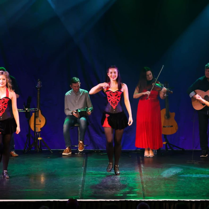 Female dancers taking centre stage during full production performance.